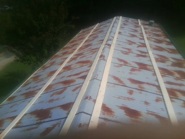 Rusted metal roof panels with new wood purlins before replacement — Storm Damage Roof Repair in Fremont Center by Roofing Brothers