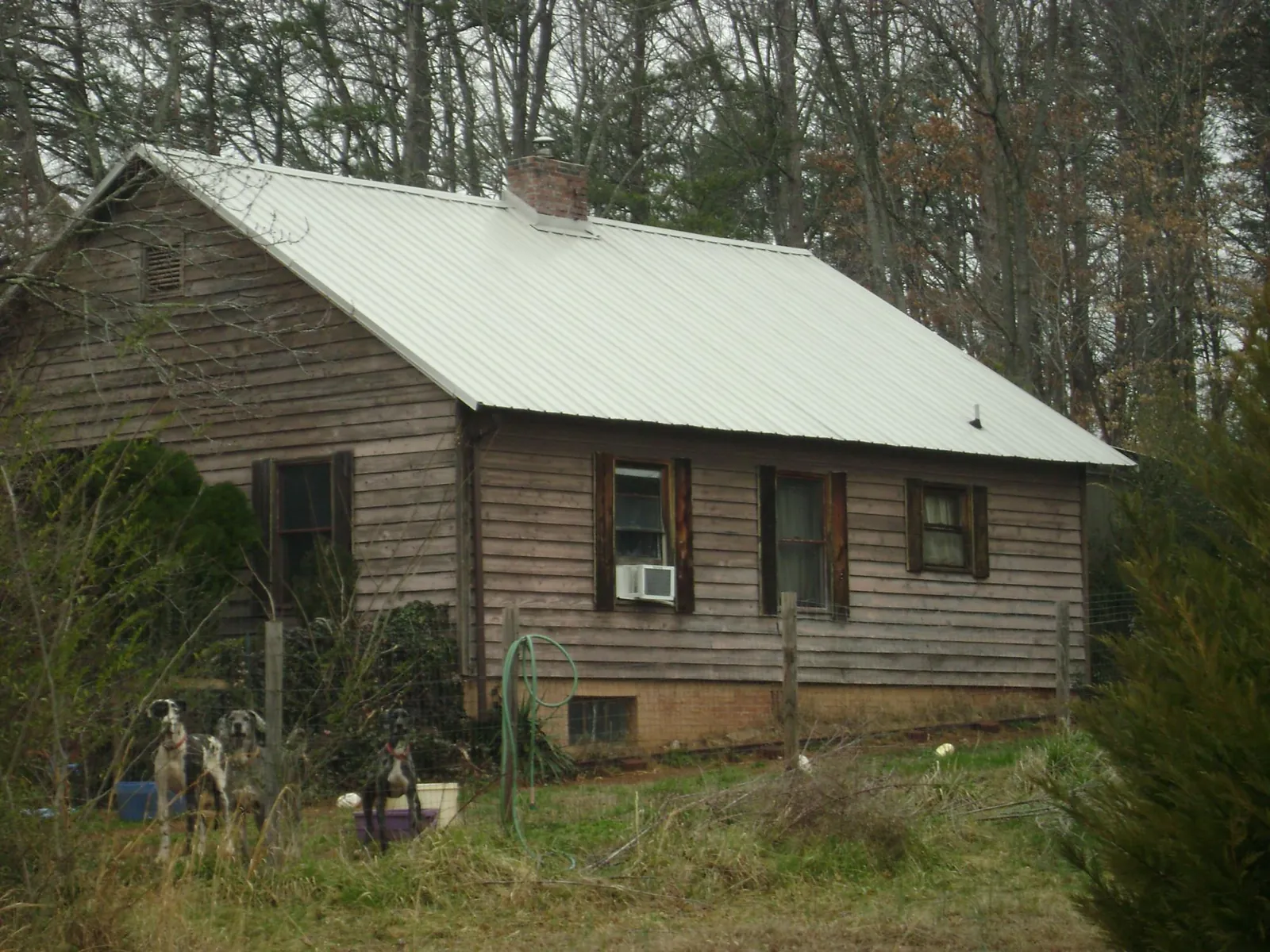 White metal roof on an old wood sided farmhouse, from a Metal Roof Installation job in Fremont Center